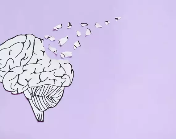 Illustration eines Gehirns, aus dem Teilchen davonfliegen - symbolisch für Demenz.