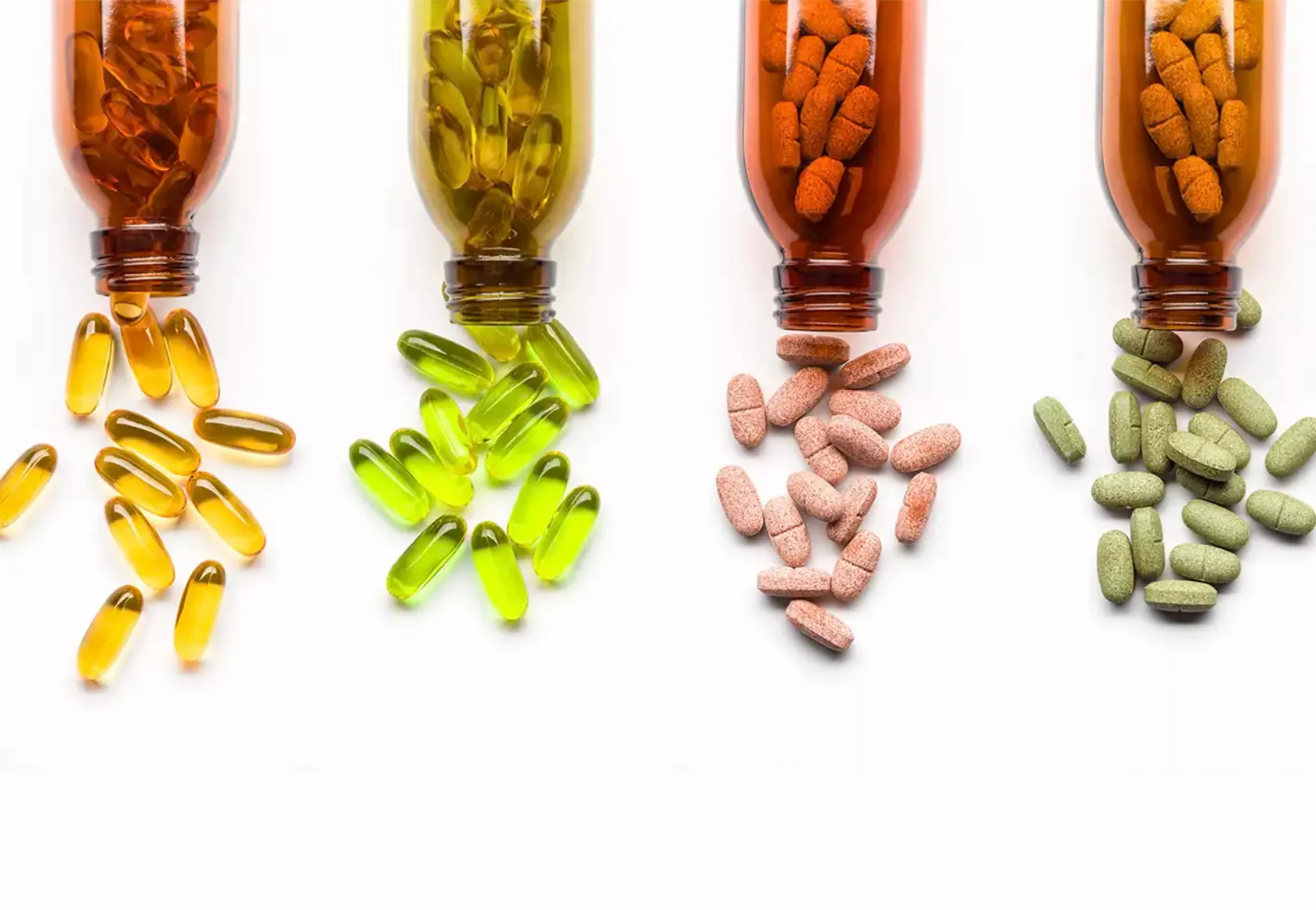 Arzneiflaschen, aus denen gelbe, grüne und rosafarbene Kapseln geschüttet werden.